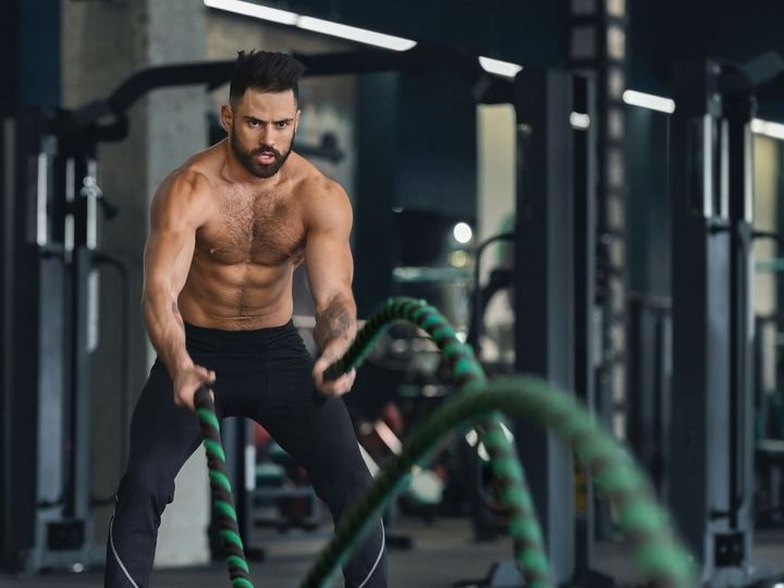 Athlete training with battle ropes